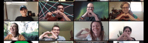 Image of a Zoom meeting with 8 people in virtual boxes making hearts with their hands