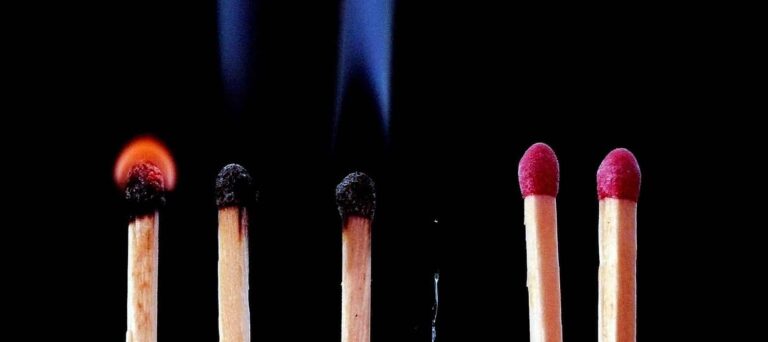 six matches in a row on a black background with a few burnt out and a few not yet light
