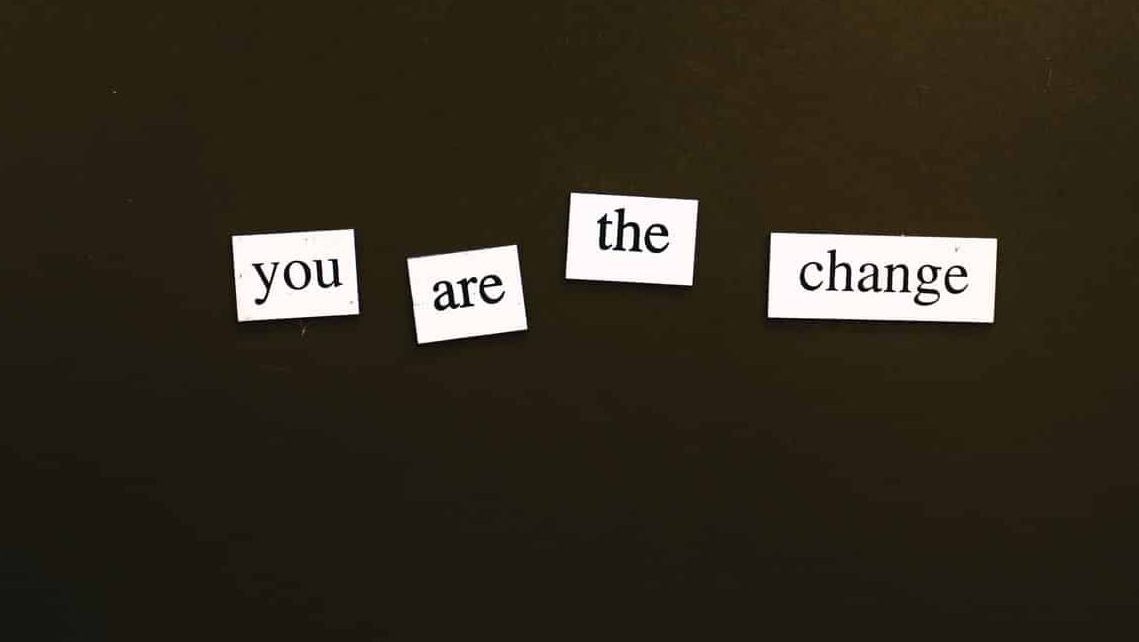 graphic with a a black background and the words; you are the change.